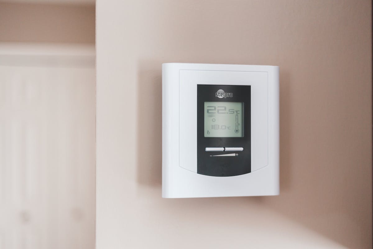 Modern digital thermostat mounted on wall