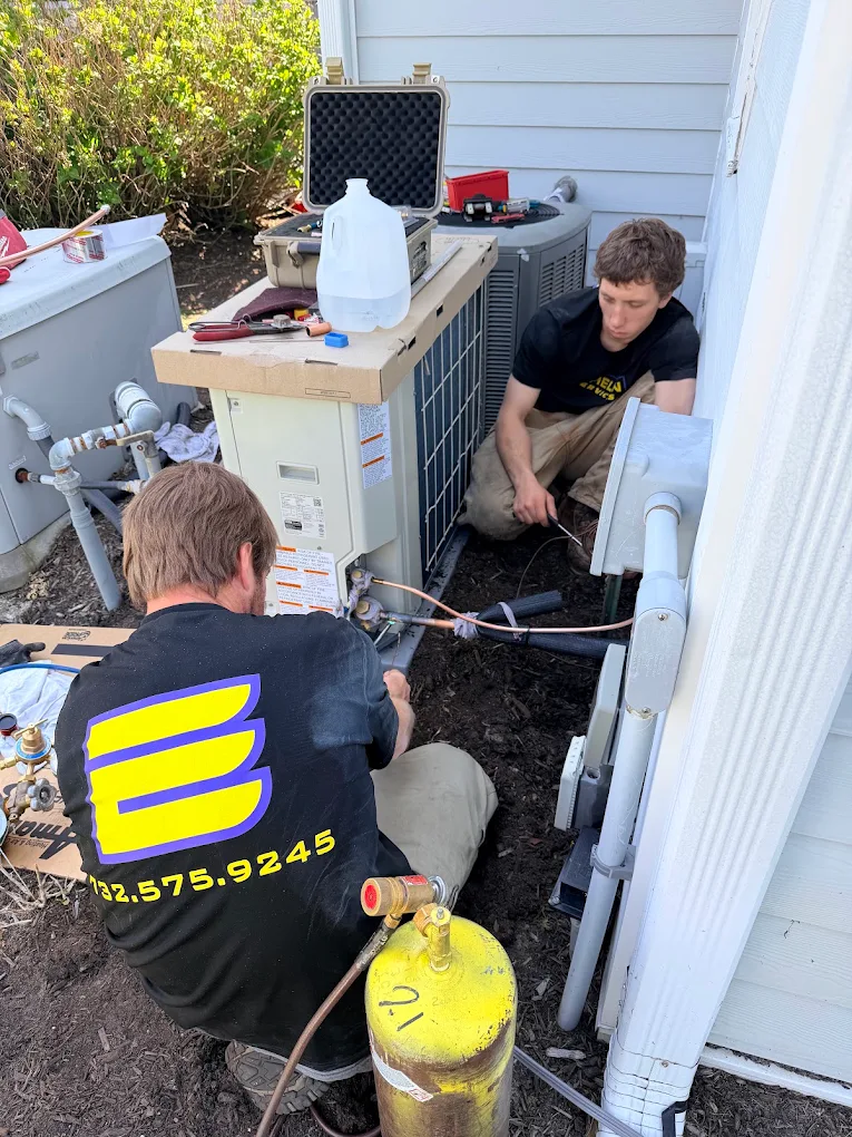 Echelon technicians installing a new AC condenser at a Jersey Shore home
